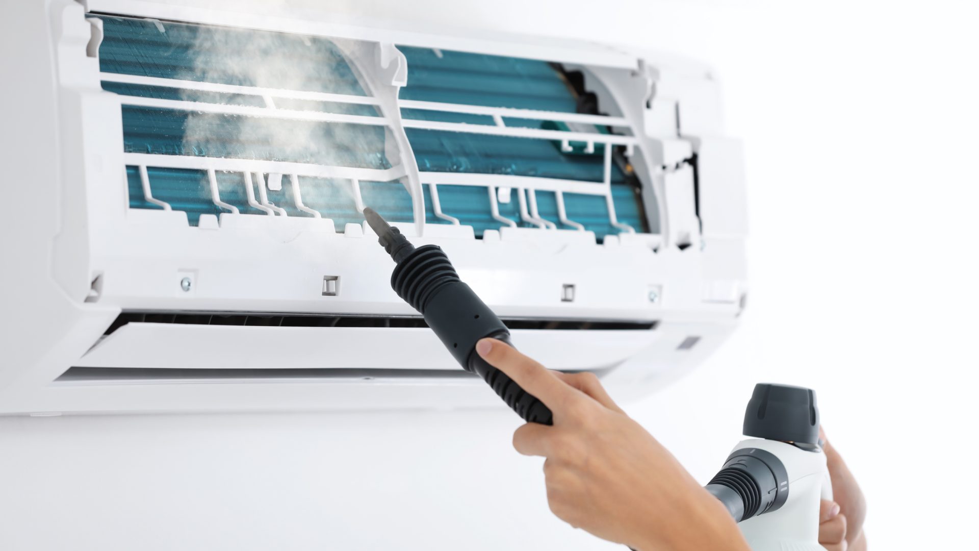 Technician cleaning air conditioner indoors